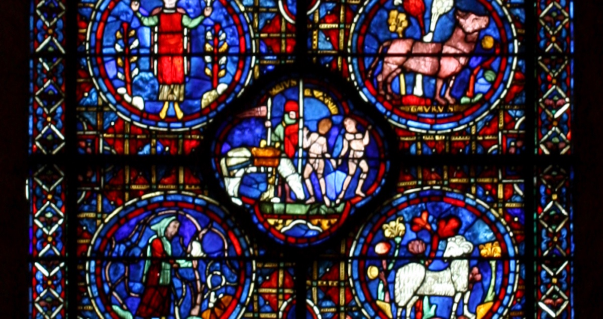 Chartres Cathedral zodiac imagery showing the months of April gathering flowers (Taurus); March pruning vines (Aries); with Gemini and a knight hunting (May) in the clover design in the middle.